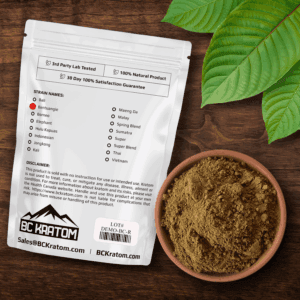 BC Kratom Red Bentuangie bag laid face down on a table beside a bowl of kratom powder