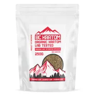 Red crushed leaf kratom contained in a white stand up pouch. The bag has red text and red mountain logo