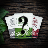 3 kratom bags laid out on a table in a spotlight. There is a large question mark on top of all of the bags