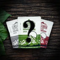 3 kratom bags laid out on a table in a spotlight. There is a large question mark on top of all of the bags